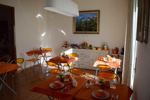 a dining room with tables and chairs and a kitchen at Residenza Wagner in Palermo