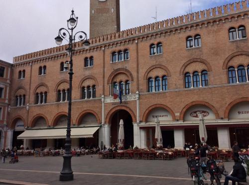 a large brick building with a clock tower at La Loggia Al Duomo - Treviso in Treviso