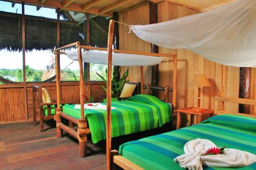 A bed or beds in a room at Pacaya Samiria Amazon Lodge - ALL INCLUSIVE