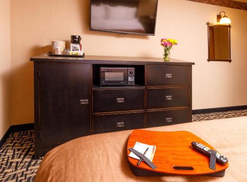 a hotel room with a wooden tray on a bed at 49'er Inn & Suites in Jackson