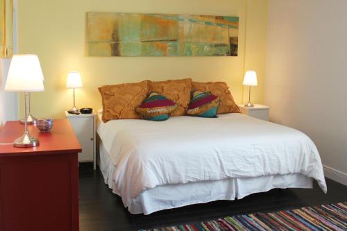 a bedroom with a white bed with two lamps at On The Beach - Lux 2 Bedroom Miami in Hollywood