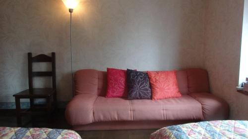 a couch with four pillows on it in a room at Gasthof Arutany in Nasu