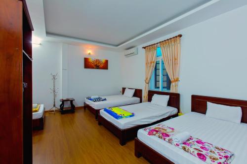 Postel nebo postele na pokoji v ubytování Mango Garden Hoi An Homestay