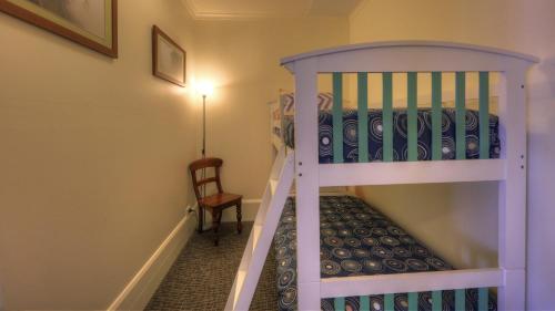 a bunk bed in a room next to a window at Dannebrog Lodge in Devonport