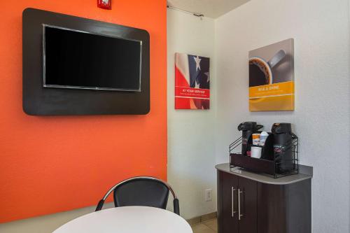 a room with a flat screen tv on a wall at Motel 6-Tucker, GA - Atlanta Northeast in Tucker