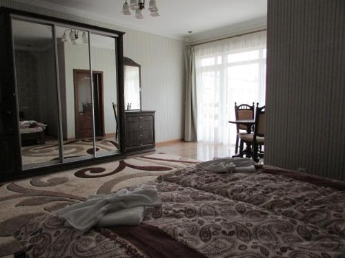 a bedroom with a large bed and a large mirror at Hotel Ashad in Svalyava