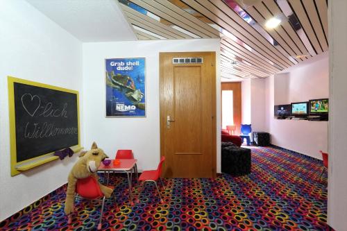a room with a stuffed dog sitting on the floor at Family Hotel Desirée in Grächen