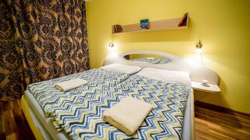 a small bedroom with a bed with two pillows on it at High Tatras - Patris 27 in Tatranska Strba