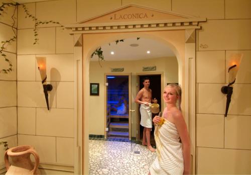 a man and a woman standing in a doorway at Hotel am Römerweg in Fiss