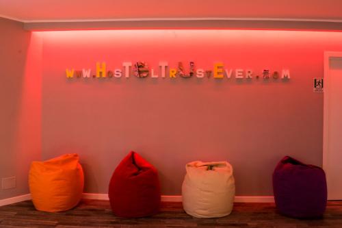 a room with five different colored bean bags against a wall at Hostel Trastevere in Rome