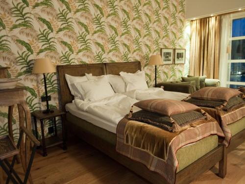 a bedroom with a large bed and a wall mural at Eriksberg Hotel & Nature Reserve in Trensum