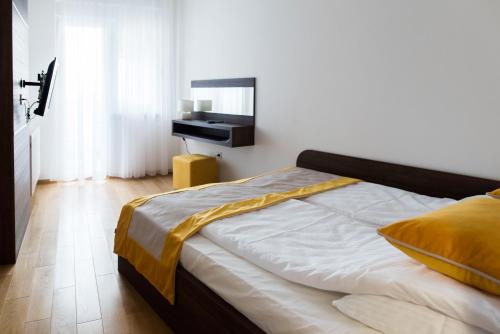 a bedroom with a bed with a mirror and a piano at Turistic Apartments Centar Sarajevo in Sarajevo