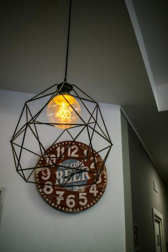 a chandelier hanging from a ceiling with a sign at Hostel Trastevere in Rome