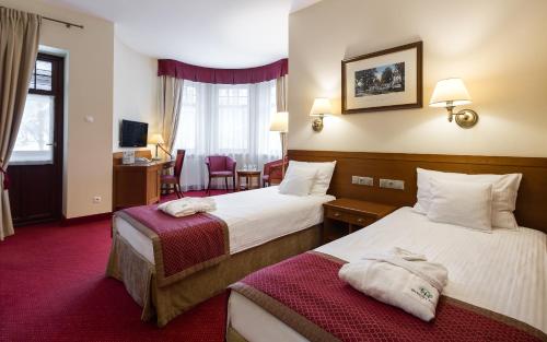 Posteľ alebo postele v izbe v ubytovaní Bukowy Park Hotel Medical SPA