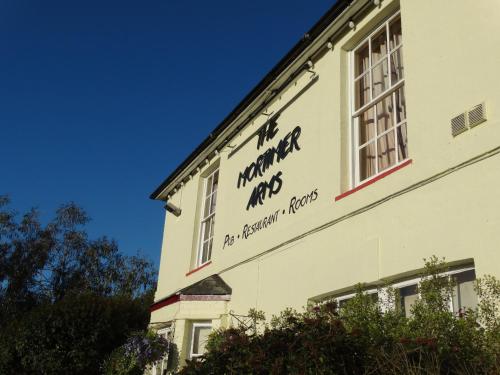 a sign on the side of a building at The Mortimer Arms in Romsey