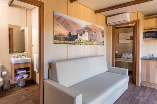 a white bed in a room with a bathroom at Magic Robin Hood in Albir