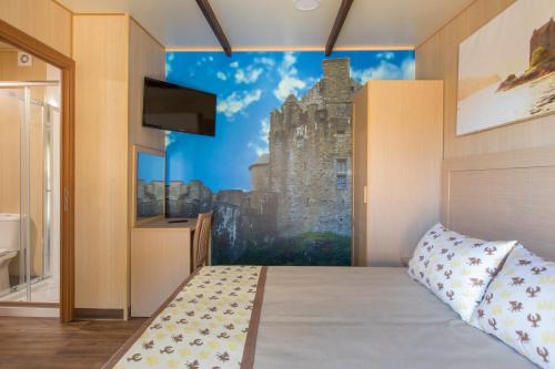 a bedroom with a wall mural of a castle at Magic Robin Hood in Albir