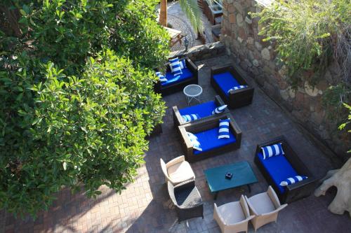an overhead view of a patio with blue and white furniture at Arava Hostel in Eilat