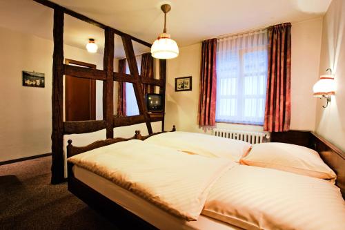 a bedroom with a large bed in a room at Gästehaus Korf in Unkel