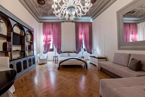 a living room with a couch and a chandelier at N4U Guest House Florence in Florence