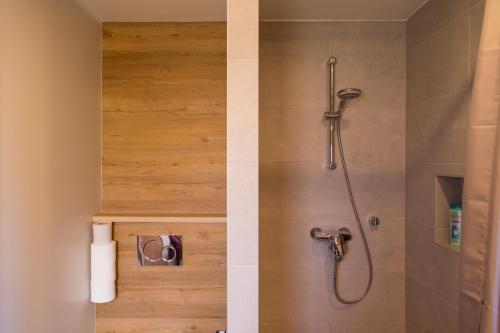 two pictures of a shower in a bathroom at Prenzel Apartments in Pärnu
