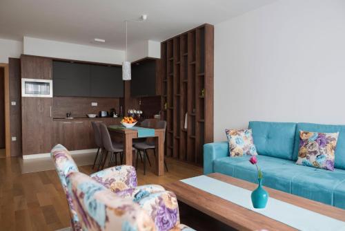 a living room with a blue couch and a table at Turistic Apartments Centar Sarajevo in Sarajevo