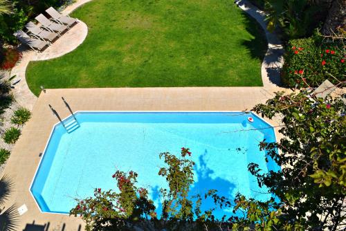 an overhead view of a swimming pool next to a lawn at Latchi Beach Front Villa - Private Heated Pool - Amazing Uninterrupted Sea Views in Polis Chrysochous