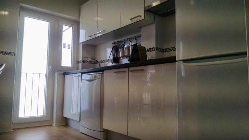 a kitchen with stainless steel appliances and a window at Estupendo piso de 3 dormitorios a 5 min a pie plaza mayor in Salamanca