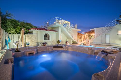 a hot tub in the backyard of a house at Fiorentinos Villa in Tragaki