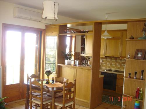 a kitchen with a table and a table and chairs at Bellevue Apartments in Sitia