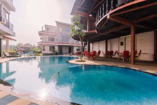 a large blue swimming pool in a building at Sia Resort in Nagaon