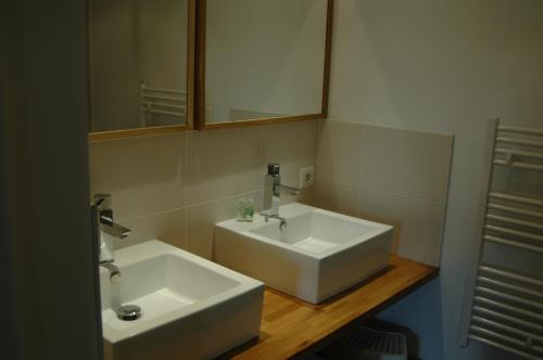 a bathroom with a white sink and a mirror at Le Clos de l'Abbaye in Cluny