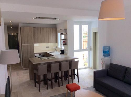 a kitchen and living room with a table and chairs at Victoria Luxury Penthouse in Málaga