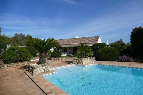 a swimming pool in front of a house at Quinta Falzina in Luz