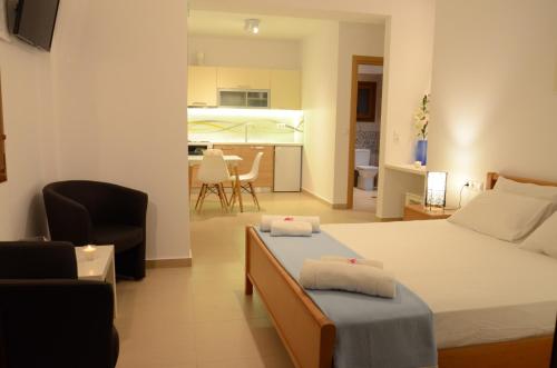a bedroom with a bed and a living room at Natsios Studios in Gaios