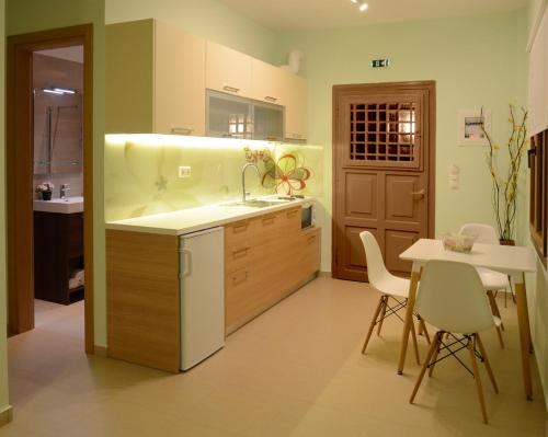 a kitchen with a sink and a table with chairs at Natsios Studios in Gaios