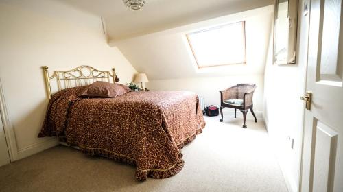 a bedroom with a bed and a window and a chair at Marvene in Thornaby on Tees