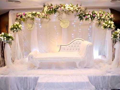 a room with a white couch on a stage with flowers at Tolip El Galaa Hotel Cairo in Cairo