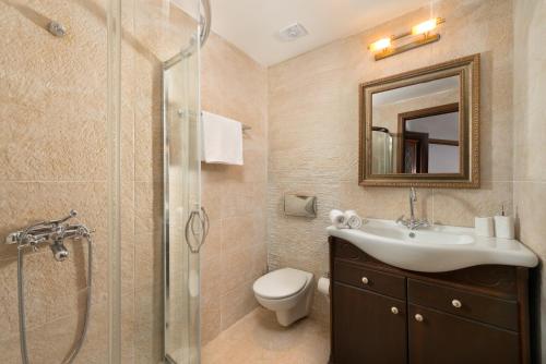 a bathroom with a sink toilet and a shower at Villa Claudia in Lardos in Lartos
