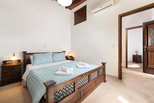 a bedroom with a bed with two towels on it at Villa Claudia in Lardos in Lartos