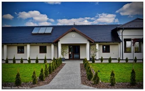 a house with solar panels on the roof at Bocskai Domb Vendégház in Nagykálló