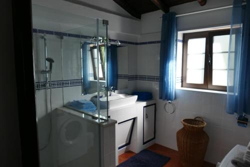 a bathroom with a glass shower and a sink at Quinta Falzina in Luz