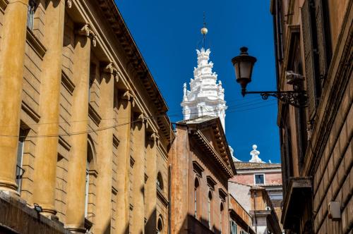 a view of a building with a clock tower in the background at Sant'Ivo Apartments in Rome