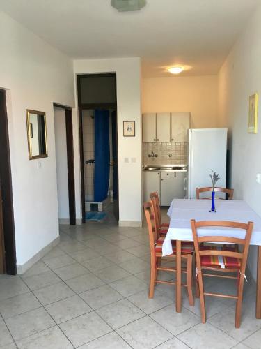 a kitchen and dining room with a table and chairs at Apartments Sugar in Mandre