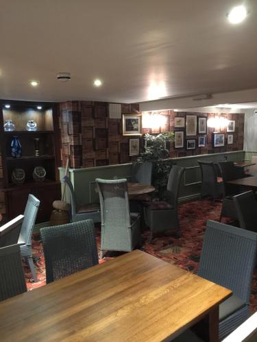 a dining room with wooden tables and chairs at The Talbot Hotel in Cleobury Mortimer