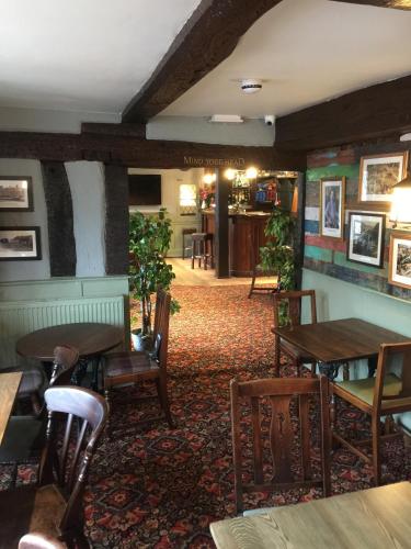 a restaurant with tables and chairs in a room at The Talbot Hotel in Cleobury Mortimer