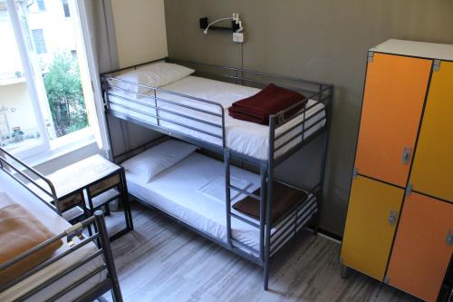 a room with two bunk beds and a window at Victoria House Hostel in Genova