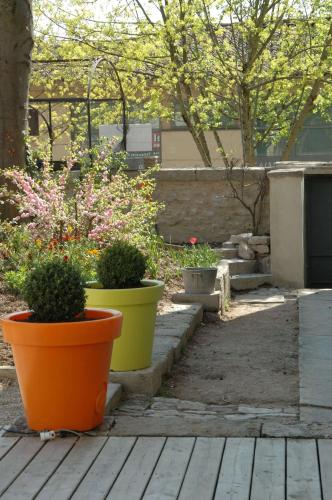three pots with plants in them sitting on a patio at Le Clos de l'Abbaye in Cluny