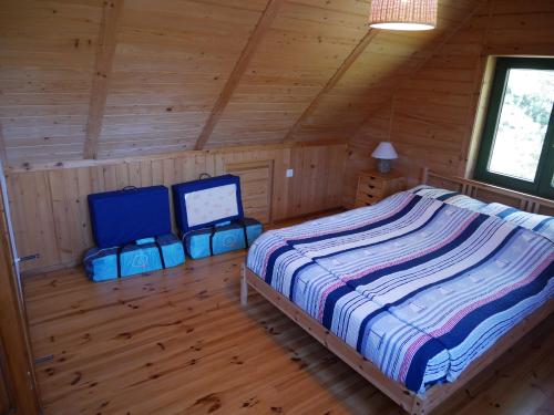 a bedroom with a bed in a wooden cabin at House NORDA in Jastrzębia Góra