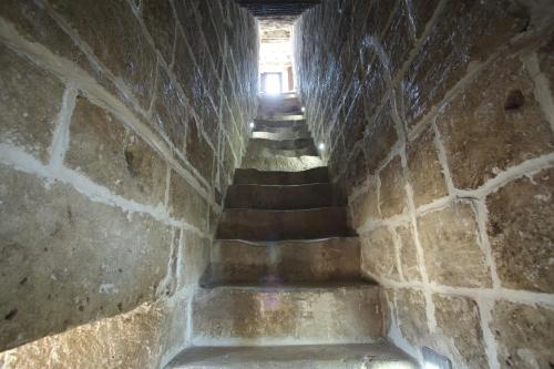 a stairway in a stone wall with stairs at Tenuta Monacelli Lecce in Lecce